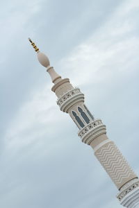 Low angle view of cross against sky