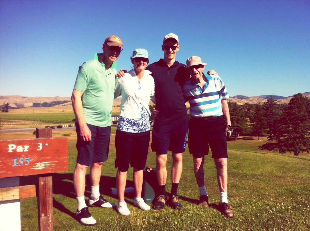 lifestyles, leisure activity, casual clothing, togetherness, clear sky, full length, men, field, blue, bonding, standing, landscape, grass, friendship, love, sunlight, sky