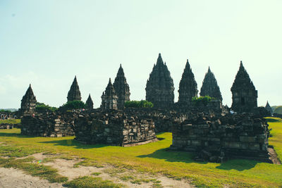Temple against building against clear sky