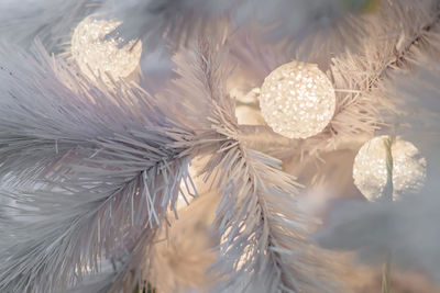 Christmas and new year holidays background. white christmas tree decorated with white balls. 