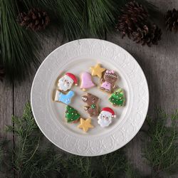 Plate with tasty christmas sugar cookies on wooden table, top view