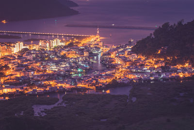 High angle view of illuminated city buildings at night