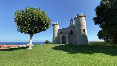 View of historic building against clear blue sky