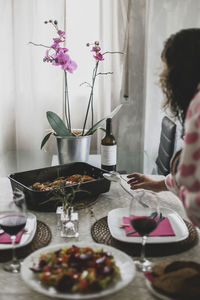 Midsection of woman having food on table