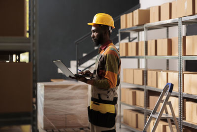 Rear view of man standing in factory