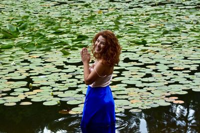 Young woman standing in water