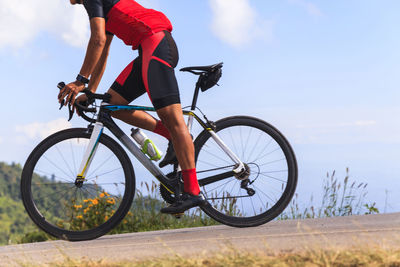 Side view of man riding bicycle