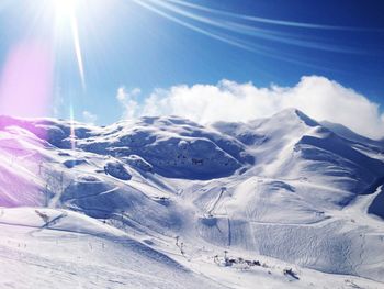 Scenic view of snow covered mountains against sky