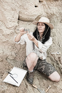 Paleontologist holding tool