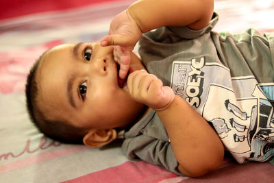 Portrait of cute boy lying on floor