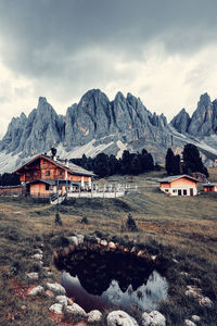 Scenic view of houses and mountains against sky