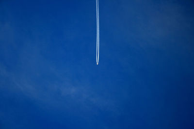 Low angle view of airplane leaving vapor trail against sky