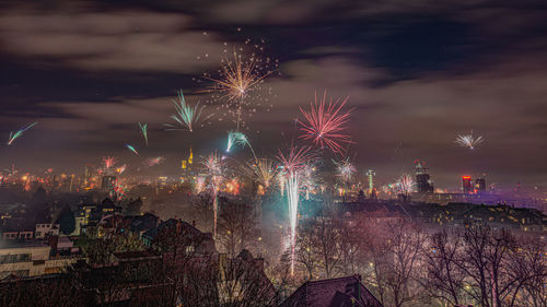 Firework display in city at night