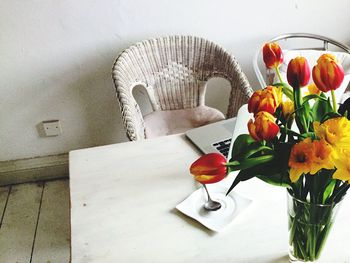 Close-up of tulips in vase on table at home