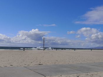 Scenic view of beach against blue sky