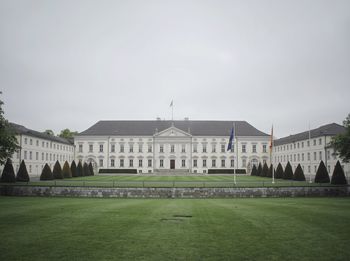 Lawn in front of government building against sky