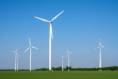 Modern wind turbines in front of a blue sky seen in rural germany