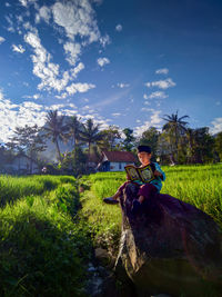 Boy sitting on field