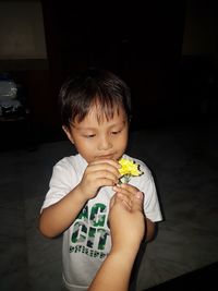 Cute boy eating baby at home