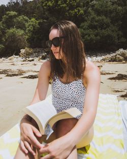 Young woman sitting on beach