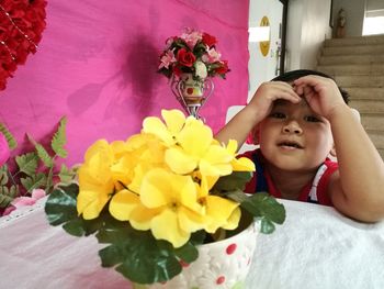 Portrait of cute boy sitting on bed