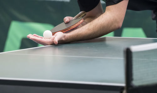Low section of person playing table tennis