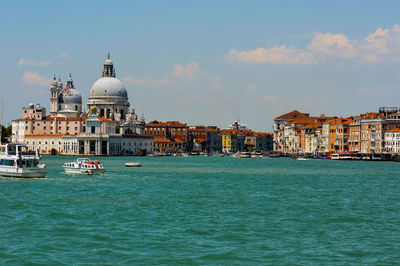 View of buildings at waterfront against sky