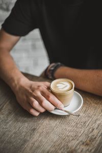 Midsection of coffee cup on table