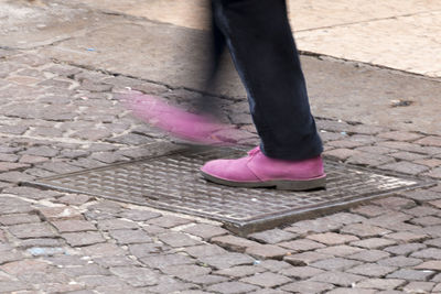 Low section of man standing on footpath