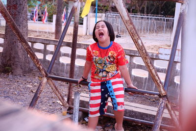 Full length of smiling girl in playground