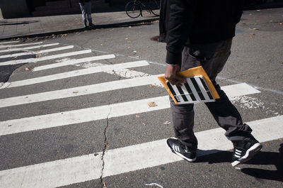Low section of man standing on road