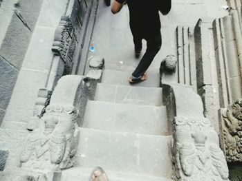 Low section of people standing on tiled floor