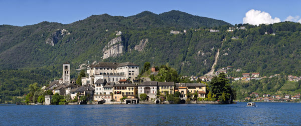 Scenic view of buildings and mountains against sky