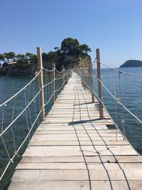 Pier over sea against clear sky