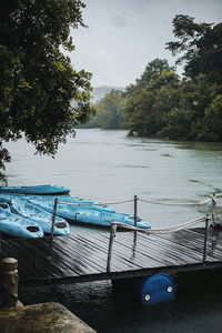 Boats moored in lake against sky