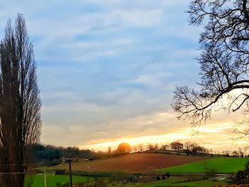 Scenic view of field against sky during sunset