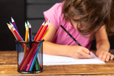 Midsection of girl holding table