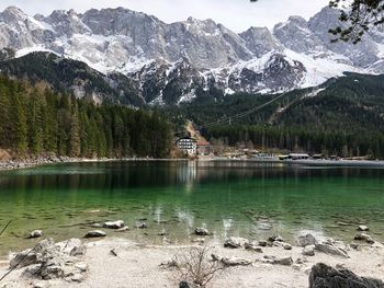 Scenic view of lake by snowcapped mountains