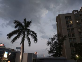 Low angle view of buildings against cloudy sky