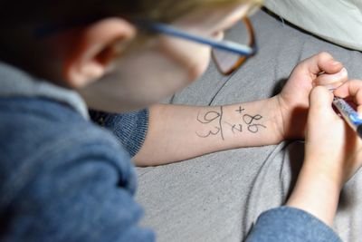 Close-up of boy writing on hand