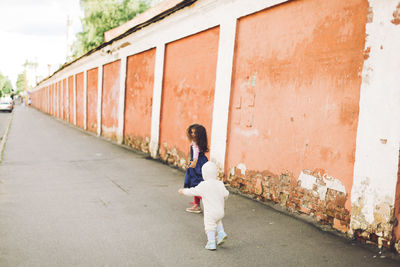 Full length of woman standing on railing