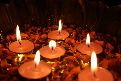 Close-up of lit candles in temple