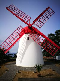 Low angle view of traditional windmill against sky