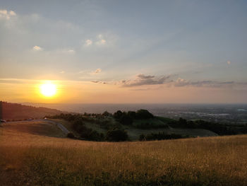 Scenic view of field against sky during sunset