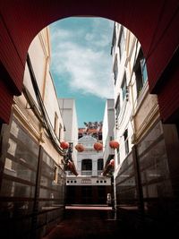 Low angle view of buildings in town against sky