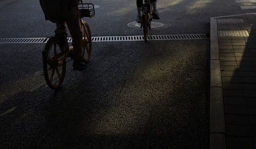 Low section of man riding bicycle on street