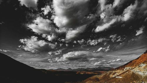 Scenic view of mountains against cloudy sky