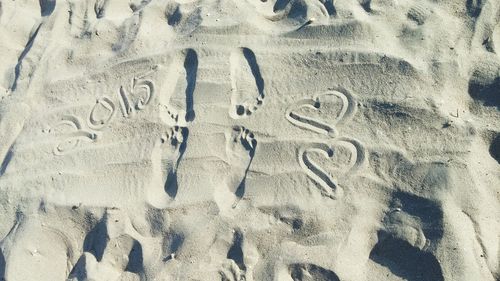 Full frame shot of text on sand