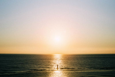 Scenic view of sea against clear sky during sunset