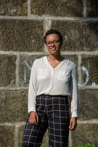 A young pretty african american businesswoman in a park with summer temperatures.